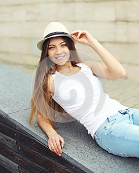 Portrait of cute smiling pretty woman wearing a summer straw hat