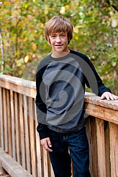 Portrait of cute teen boy outdoors.