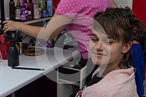 Portrait of cute teen girl in hairdresser salon