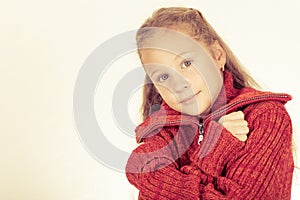 Portrait of a cute teen girl in red sweater