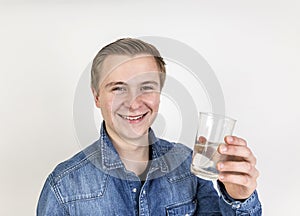 Portrait of cute teenage boy drinking water