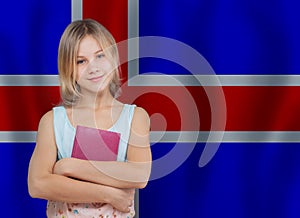 Portrait of cute teenager girl holding book on flag of Iceland background