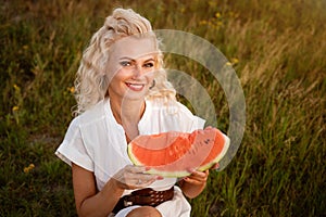 Portrait of a cute woman with a piece of watermelon in her