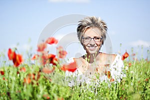 Portrait of cute woman in poppy field