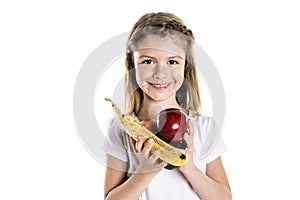 Portrait of a cute 7 years old girl Isolated over white background with apple, banana and avocado