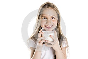 Portrait of a cute 7 years old girl Isolated over white background with milk glass