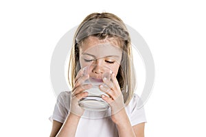 Portrait of a cute 7 years old girl Isolated over white background with milk glass