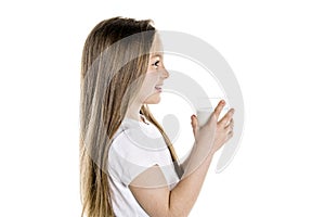 Portrait of a cute 7 years old girl Isolated over white background with milk glass