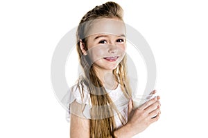 Portrait of a cute 7 years old girl Isolated over white background with milk glass