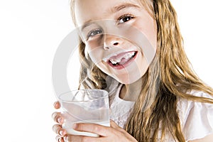 Portrait of a cute 7 years old girl Isolated over white background with milk glass