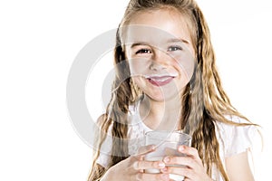 Portrait of a cute 7 years old girl Isolated over white background with milk glass