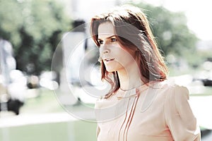 Portrait of cute young business woman outdoor over building background