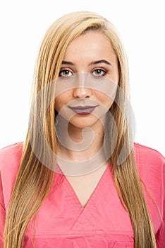 Portrait of cute young female nurse wearing scrubs smiling