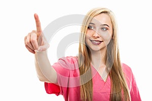 Portrait of cute young female nurse wearing scrubs using touchscreen