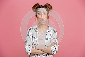 Portrait of a cute young girl blowing gum bubble