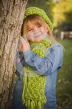 Portrait of Cute Young Girl Wearing Green Scarf and Hat