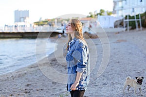 Portrait of cute young woman who poses and smiles in camera, sta