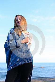 Portrait of cute young woman who poses and smiles in camera, sta