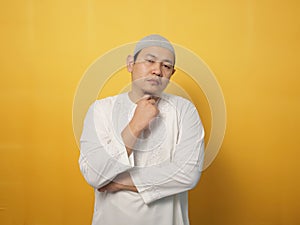 Portrait of cynical Asian muslim man with suspicious expression looking and starring, mistrust misdoubt