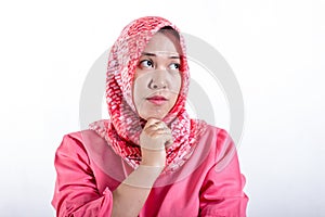 Portrait of cynical Asian muslim woman with suspicious expression