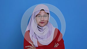 Portrait of cynical Asian muslim woman with suspicious expression looking and starring, mistrust misdoubt