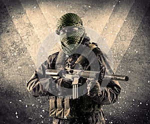 Portrait of a dangerous masked armed soldier with grungy background