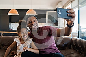 Daughter and father taking a selfie with phone. photo