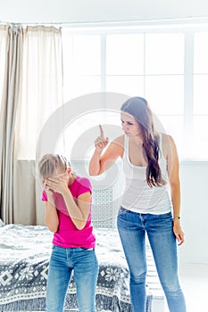 A portrait of a daughter and mother having quarrel at home