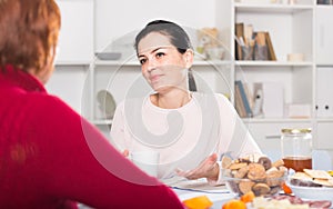 Portrait of daughter talking with mature woman