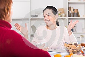 Portrait of daughter talking with mature woman