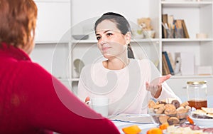 Portrait of daughter talking with mature woman