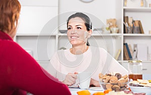 Portrait of daughter talking with mature woman