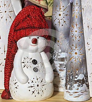 Portrait of a decorative toy snowman in a long red knitted hat