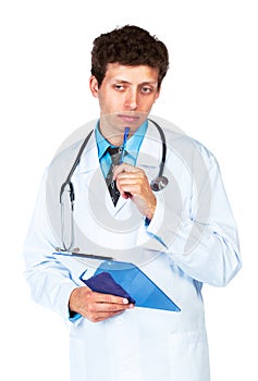 Portrait of deliberating young male doctor writing on a patient'