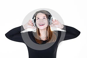 Portrait of a delighted young woman listening headphones earphones music