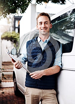 Portrait, delivery and a courier man with his van, holding a clipboard for an order or address. Logistics, ecommerce and