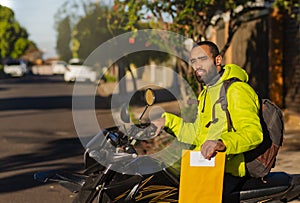 Portrait of delivery man with parcel in envelope. Document delivery concept