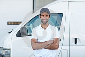 Portrait of delivery man is posing with crossed arms