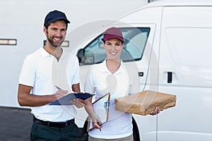 Portrait of delivery people are holding goods and smiling to the camera