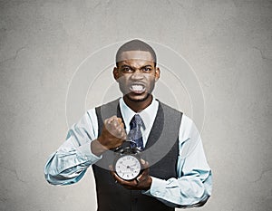 Portrait of demanding corporate boss holding alarm clock screaming at his employees