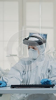 Portrait of dental assistent typing on computer keyboard