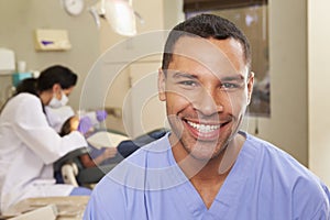 Portrait Of Dental Nurse In Dentists Surgery photo