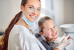 Portrait, dentist and happy child with woman in clinic for medical exam, orthodontics or cleaning teeth. Face, smile and