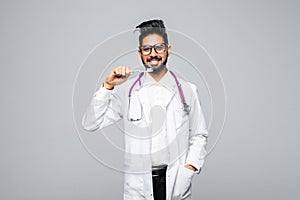 Portrait of a dentist holding a toothbrush, isolated on white background with copy space