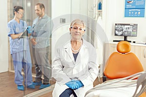 Portrait of dentist senior woman waiting for sick patient in stomatology hospital