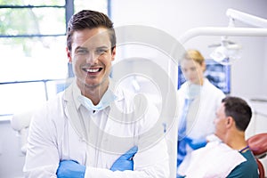 Portrait of dentist standing with arms crossed