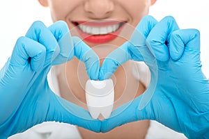 Portrait of dentist with tooth on white background