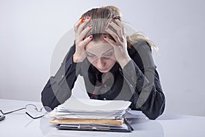 Portrait of depressed business woman working in office as symbol of low wages, overtime working hours and lack of career prospects