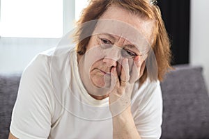 Portrait of depressed elderly woman having worries