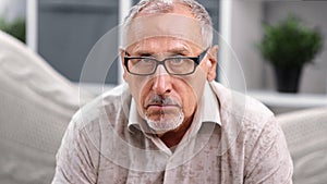 Portrait of depressed mature man in glasses with sad face expression. Close up shot on 4k RED camera